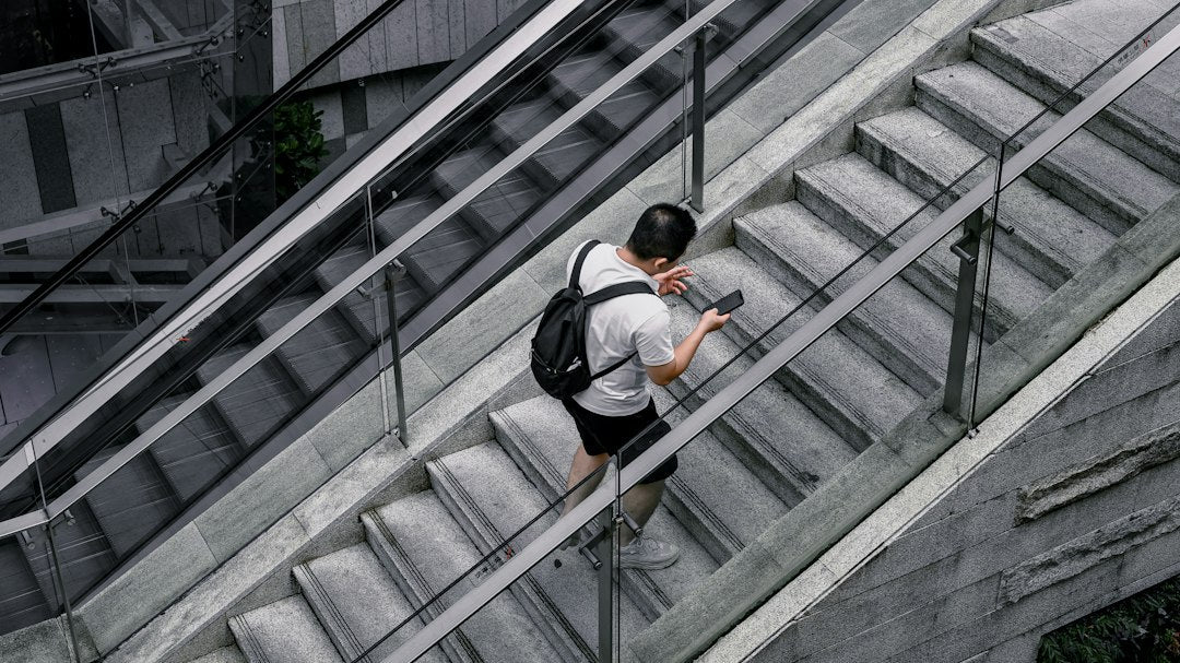 a man with a backpack is walking down a set of stairs
